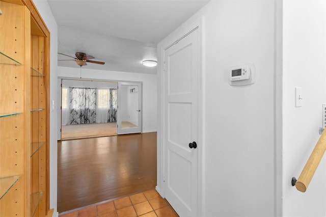 hall featuring light tile patterned floors