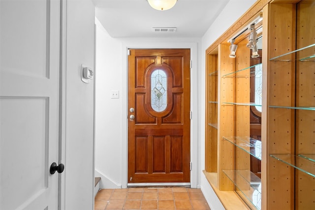 doorway featuring light tile patterned flooring