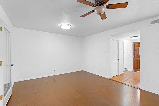 spare room with ceiling fan, a textured ceiling, and light hardwood / wood-style floors