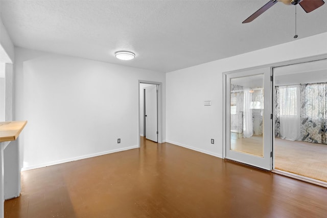 unfurnished room featuring ceiling fan and a textured ceiling