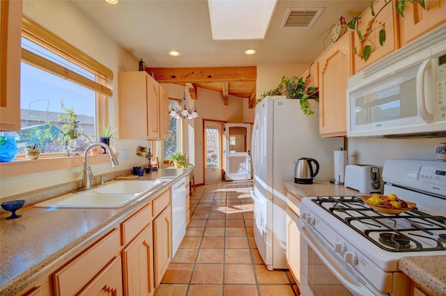 kitchen featuring light tile patterned flooring, sink, an inviting chandelier, and white appliances