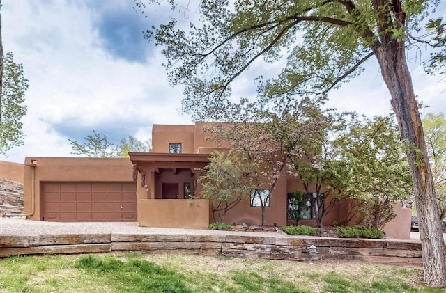 707 E Palace Ave Unit 15, Santa Fe, NM 87501 - pueblo revival-style home featuring a garage and stucco siding
