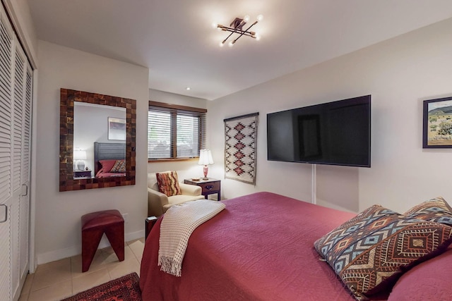 bedroom featuring light tile patterned flooring and a closet