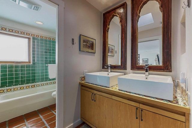 bathroom featuring tile patterned flooring, vanity, and toilet