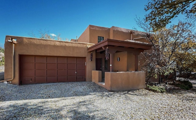 pueblo-style home with a garage