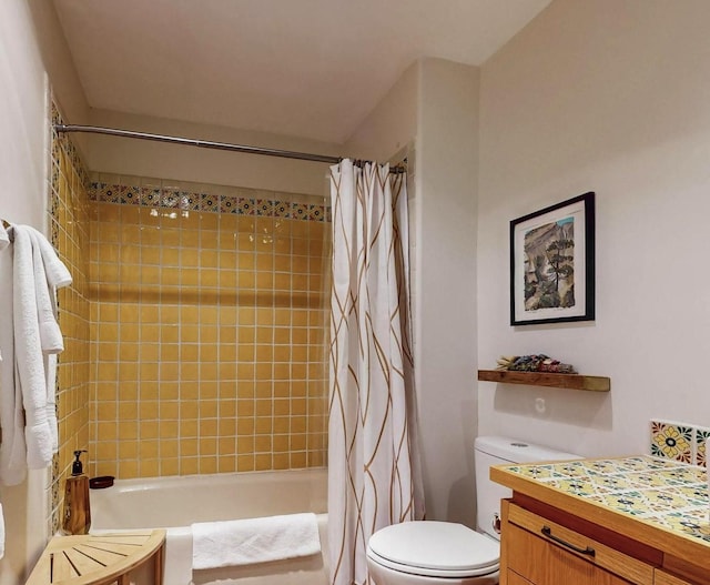 full bathroom featuring toilet, vanity, and shower / bathtub combination with curtain