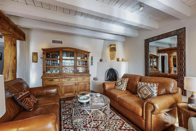 living room featuring wood ceiling, beam ceiling, and decorative columns