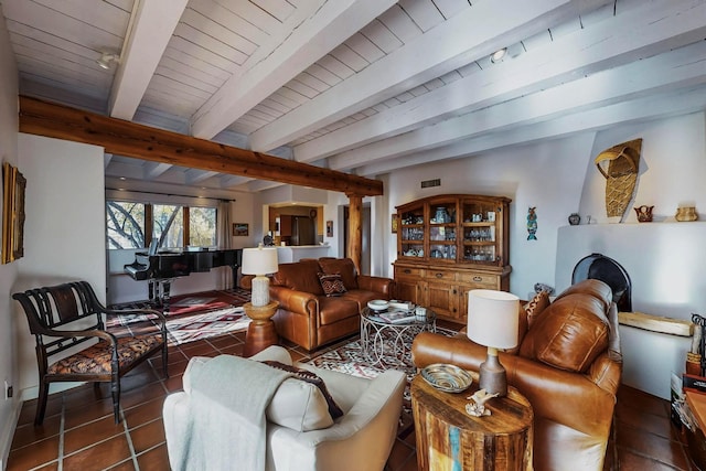 living room featuring dark tile patterned flooring, beam ceiling, and wooden ceiling