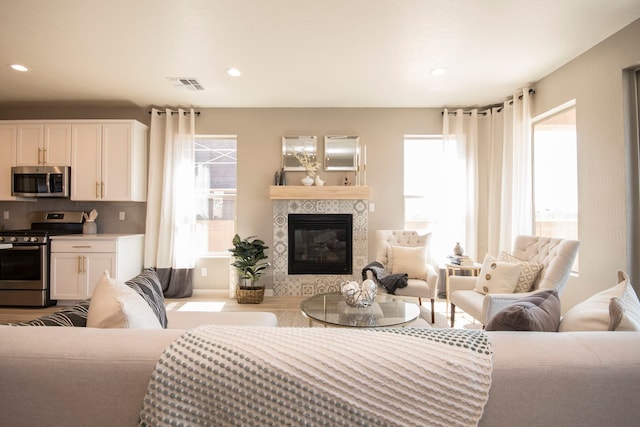 living room with a fireplace and light hardwood / wood-style floors