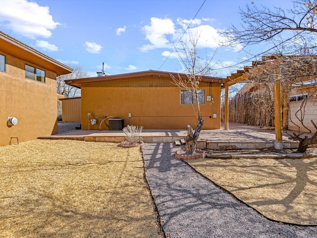 rear view of house with a patio and central AC unit