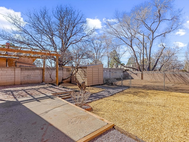 view of yard with a fenced backyard, an outdoor structure, a patio, and a shed