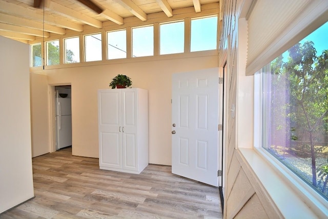 unfurnished sunroom featuring wooden ceiling and beam ceiling