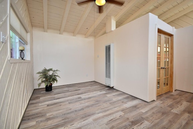 empty room with ceiling fan, vaulted ceiling with beams, wooden ceiling, and light wood-type flooring