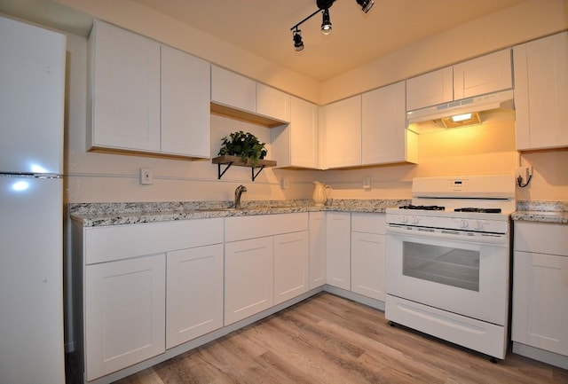 kitchen with white cabinetry, white range with gas stovetop, and light hardwood / wood-style flooring