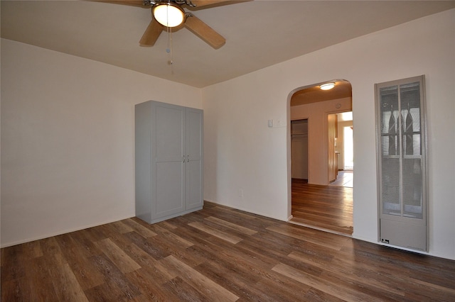 unfurnished room featuring ceiling fan and dark hardwood / wood-style flooring