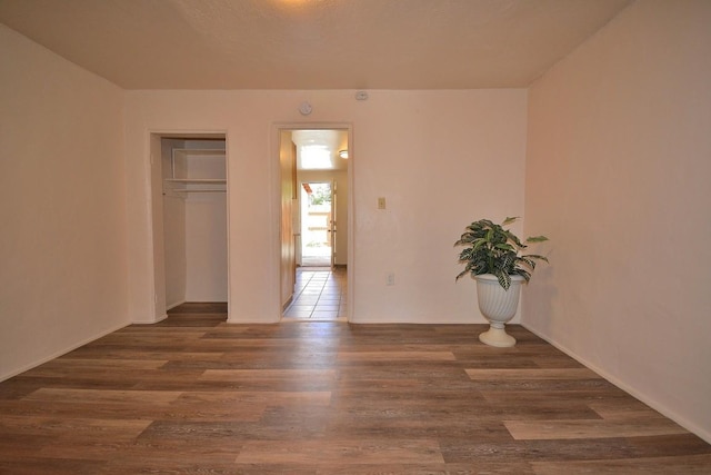 unfurnished room featuring dark hardwood / wood-style flooring