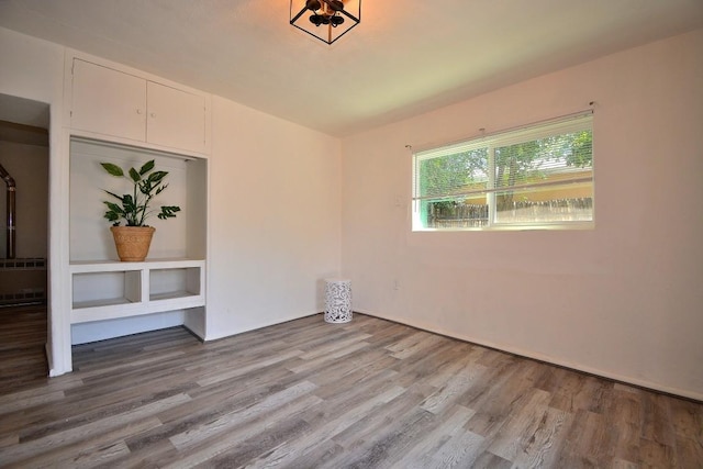 empty room with radiator and light hardwood / wood-style flooring