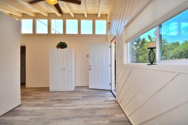 interior space featuring beam ceiling, light hardwood / wood-style flooring, and wooden ceiling