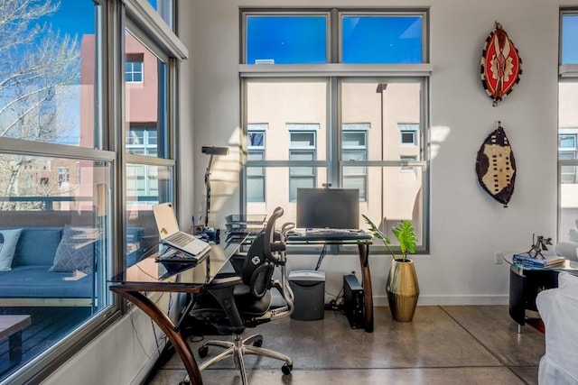 home office featuring concrete flooring