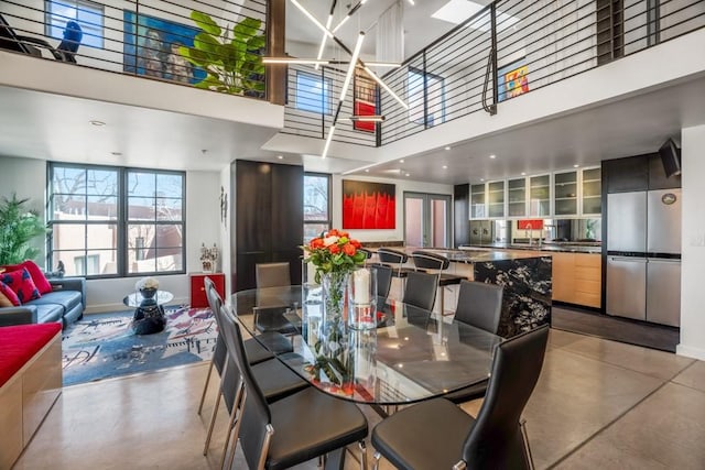 dining area with a towering ceiling