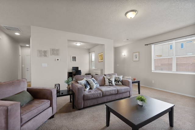 carpeted living room with a textured ceiling