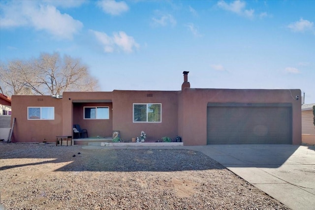 pueblo-style home featuring a garage