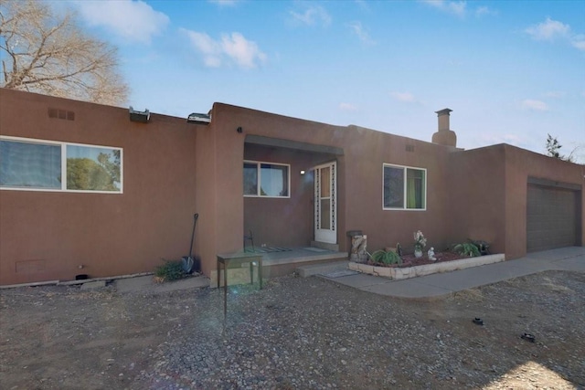 adobe home featuring a garage