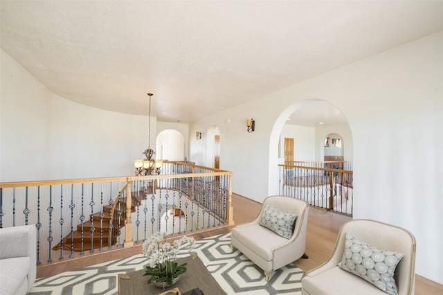 sitting room featuring an inviting chandelier and hardwood / wood-style floors