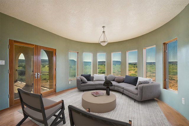 sunroom / solarium featuring a healthy amount of sunlight and french doors