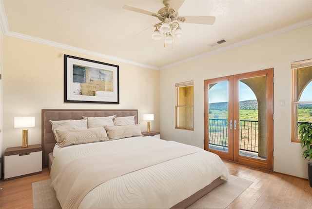 bedroom with french doors, ornamental molding, ceiling fan, access to exterior, and light hardwood / wood-style floors