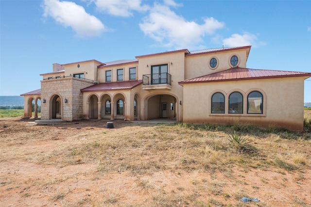 mediterranean / spanish-style home featuring a balcony