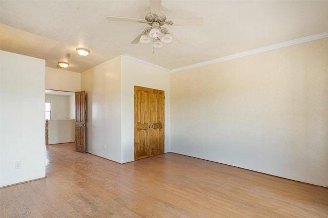 spare room featuring ornamental molding, ceiling fan, and light hardwood / wood-style flooring