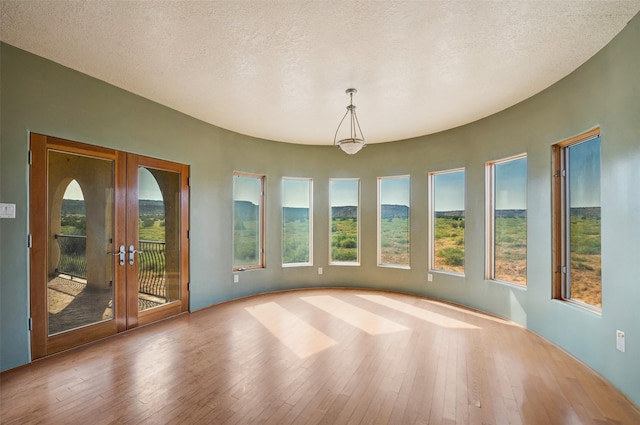 unfurnished sunroom featuring french doors