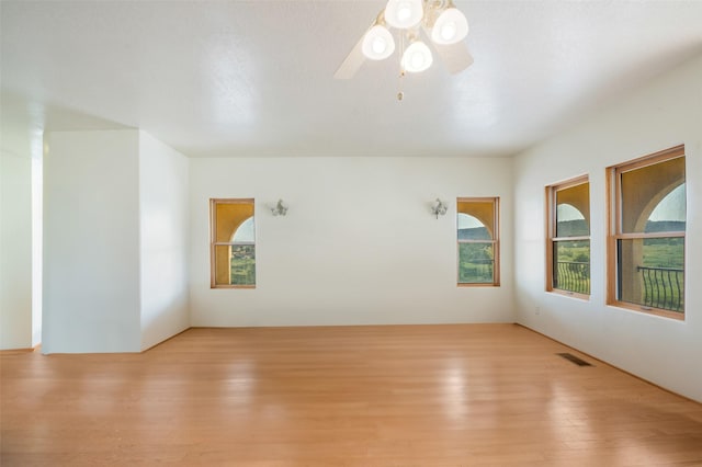 empty room featuring ceiling fan and light hardwood / wood-style floors