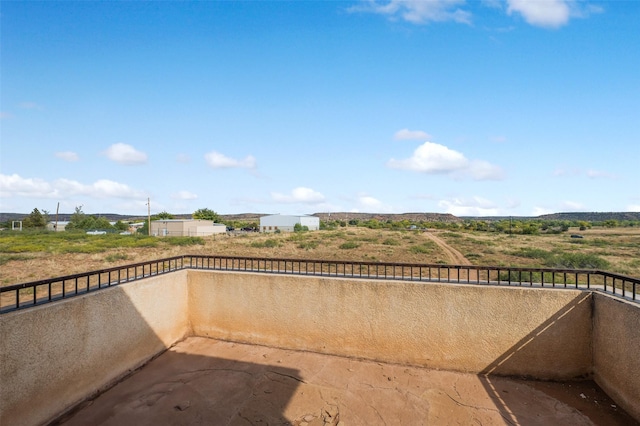 view of patio featuring a balcony