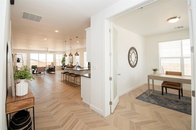 hallway featuring light parquet flooring