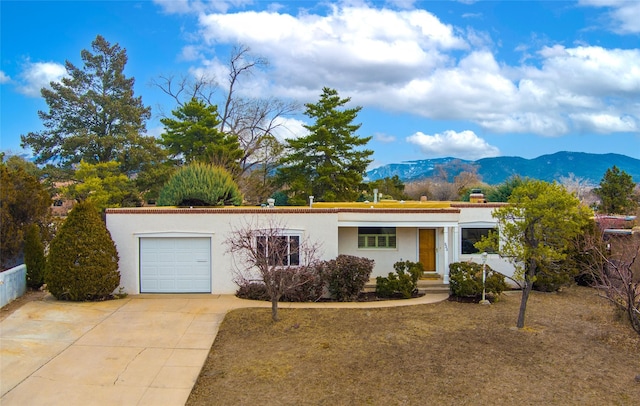 single story home featuring a mountain view and a garage