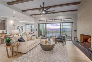 living room with hardwood / wood-style floors, beam ceiling, and ceiling fan