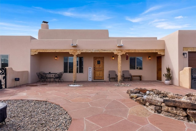 back of property with a patio