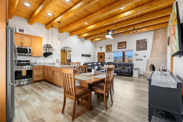 dining area with beam ceiling, wood ceiling, ceiling fan, and light wood-type flooring