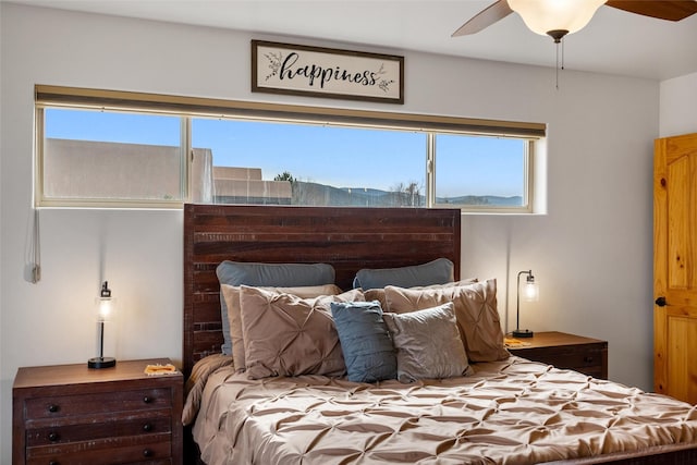 bedroom with a mountain view and ceiling fan