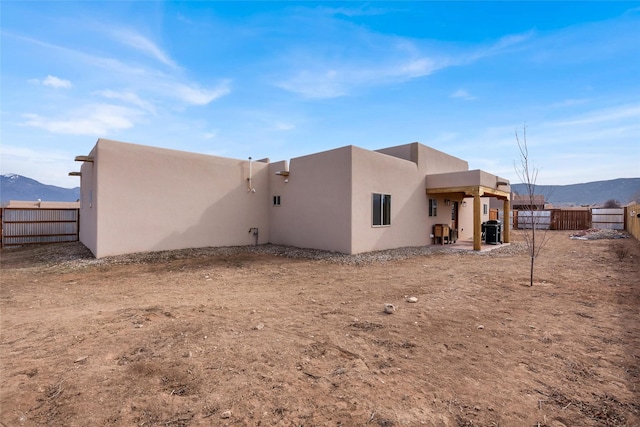 rear view of house featuring a mountain view