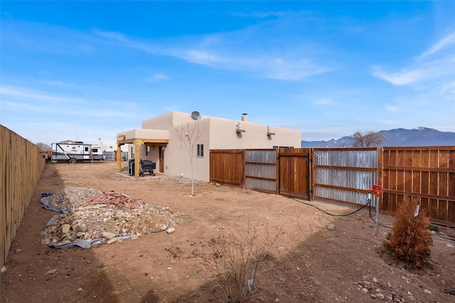 back of house with a mountain view