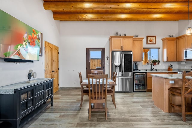 kitchen with stainless steel appliances, wine cooler, beam ceiling, and wood ceiling