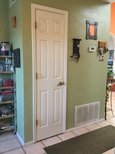 hallway featuring light tile patterned floors