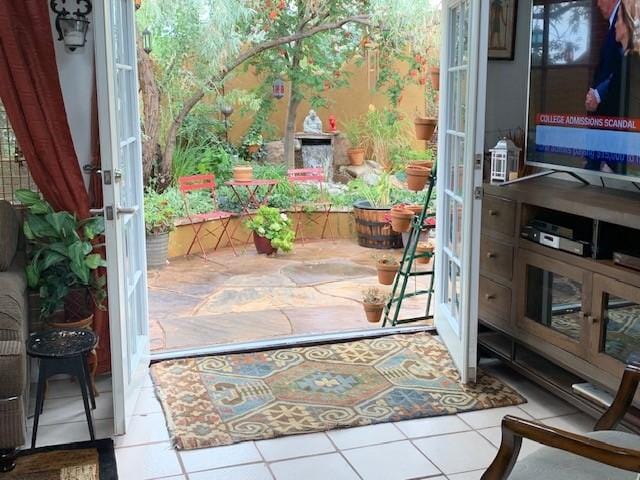 doorway to outside featuring tile patterned flooring and french doors