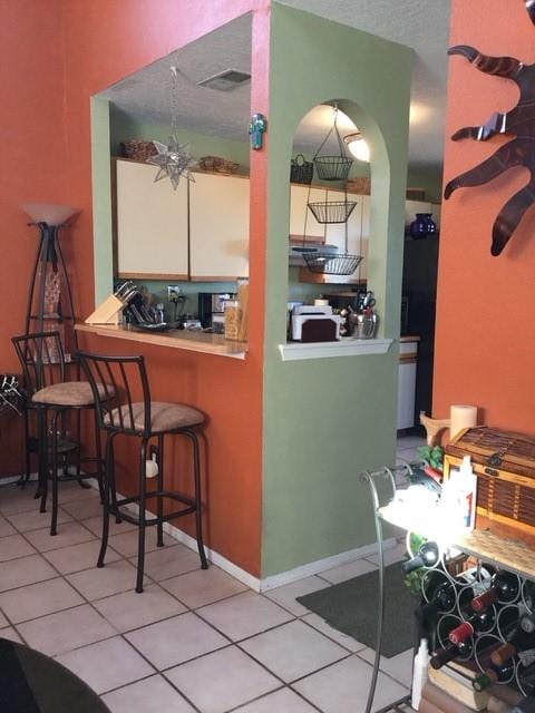 kitchen with light tile patterned floors and a textured ceiling