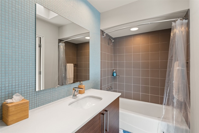 bathroom with shower / bath combination with curtain, decorative backsplash, vanity, and tile walls