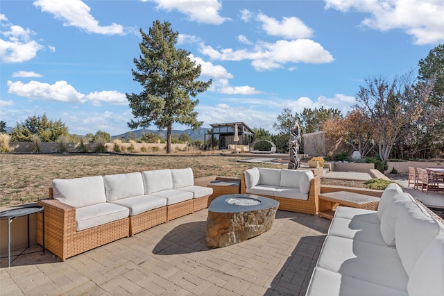 view of patio / terrace featuring an outdoor living space with a fire pit