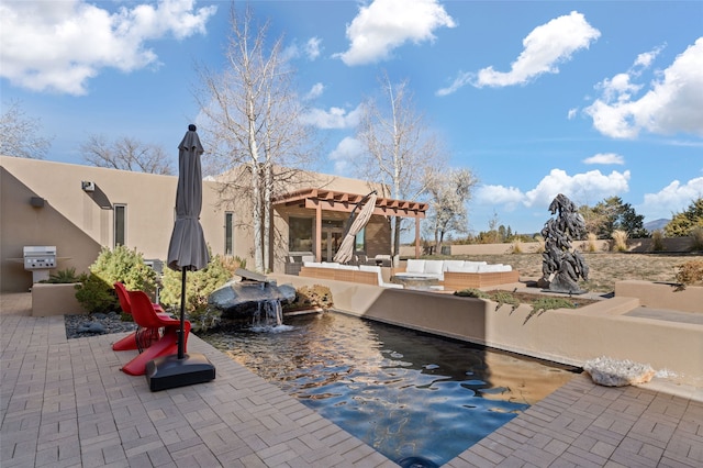 view of patio with area for grilling, outdoor lounge area, and a pergola